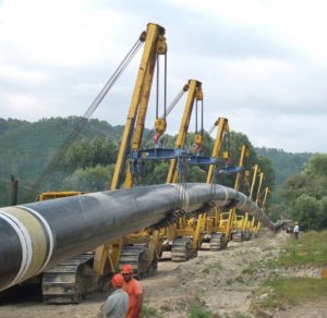 A picture of a pipeline being lowered in to a trench